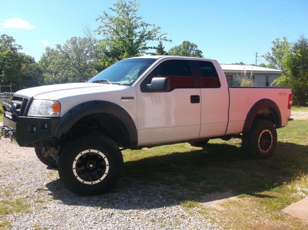 Customized 2007 Ford F 150 lifted with camper top